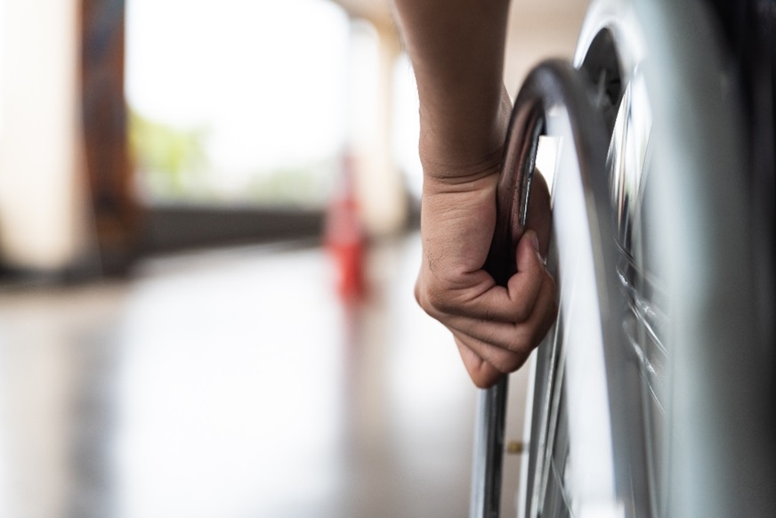 Wheelchair user going down a corridor